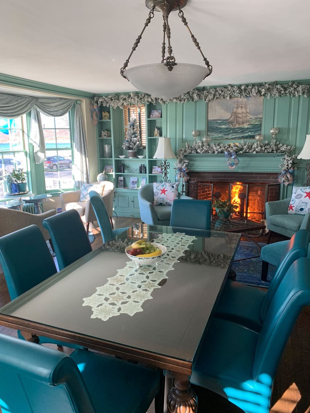 The common room at the Harborview Inn, long table set for breakfast beside the fireplace