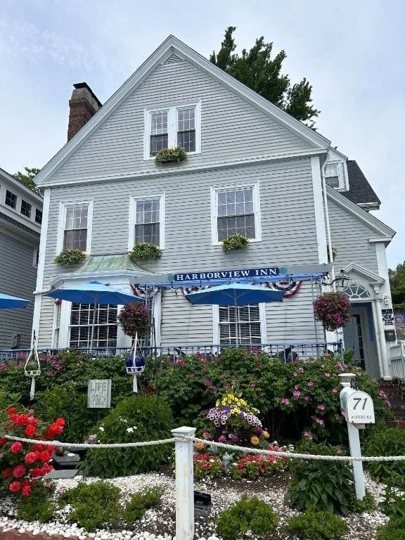 The front of the Harborview Inn at 71 Western Ave, its sign and blue awnings