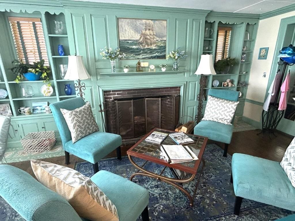 The lobby fireplace at the Harborview Inn, lit, with seating around it